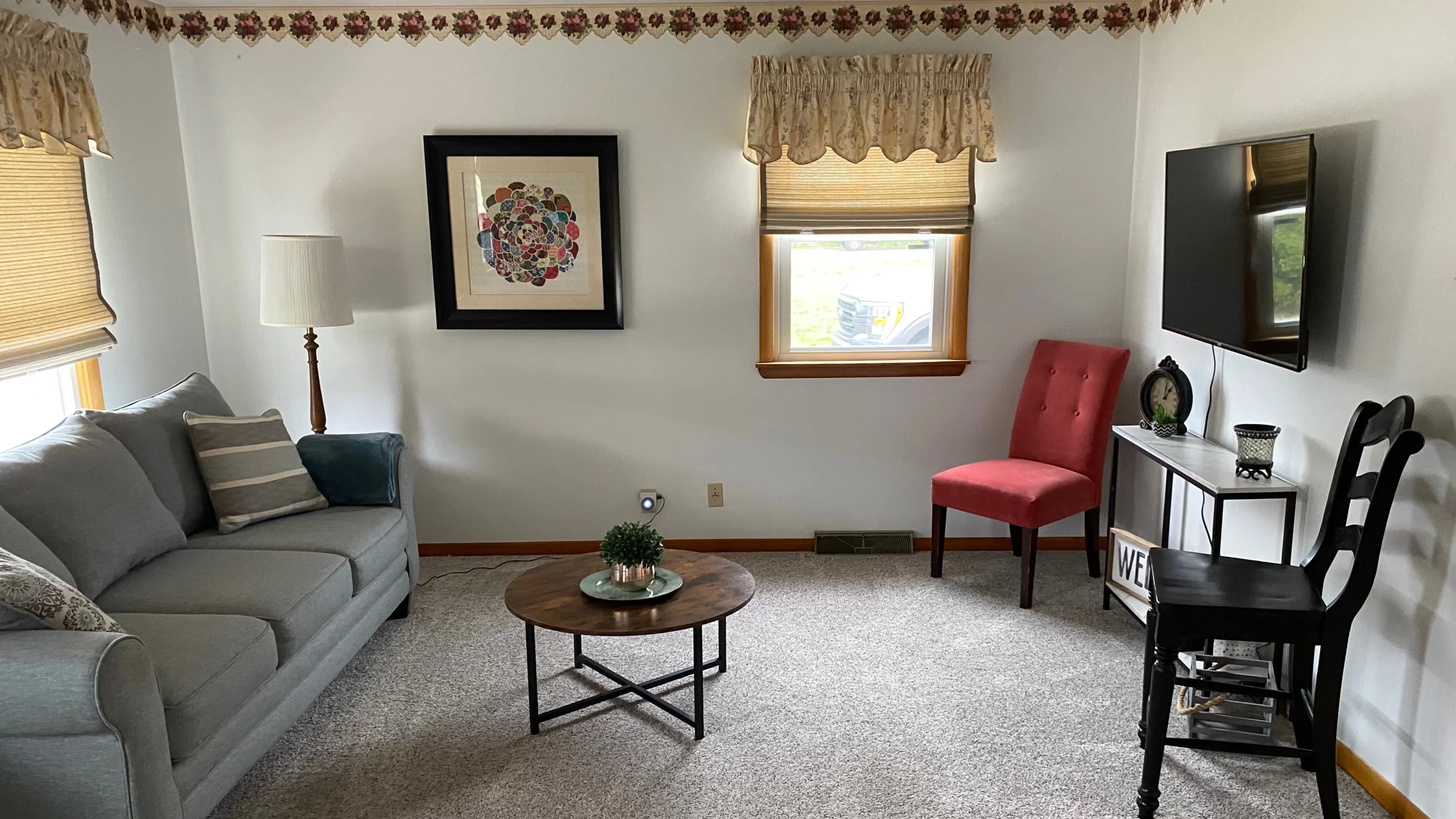 a grey couch, red chair and updated living room